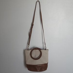 Raffia woven crossbody bag with faux leather and wooden handle by Street Level